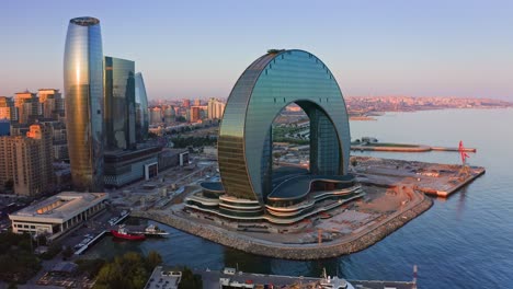 Flying-around-modern-business-quarter-nearby-Caspian-bay-in-Baku,-Azerbaijan