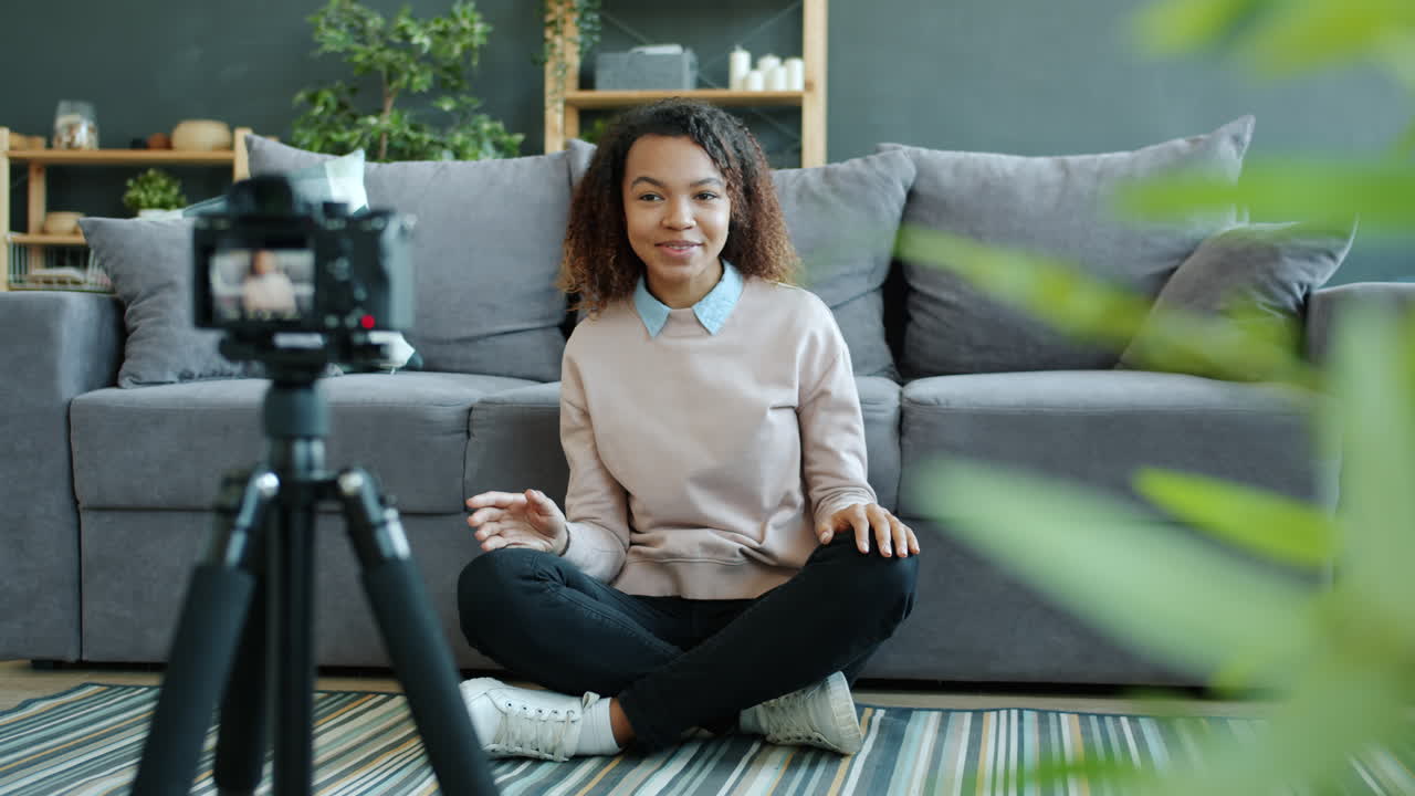 Young woman vlogging in her living room