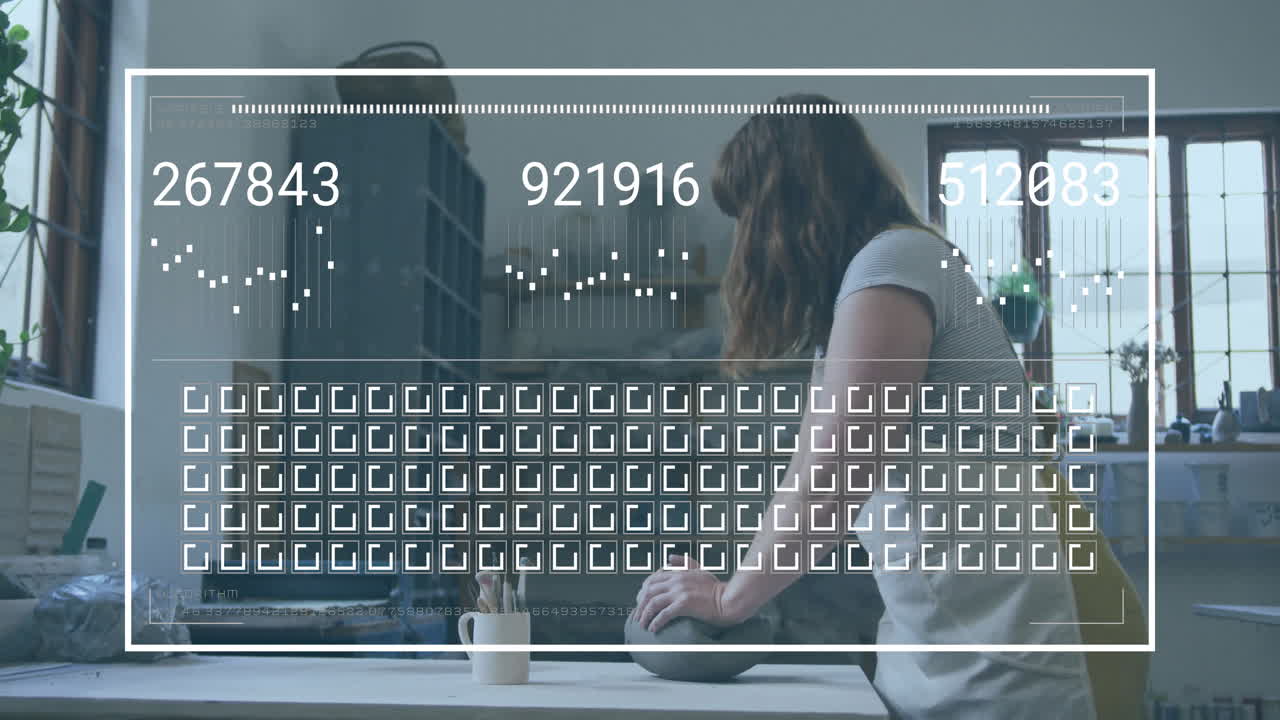 Sitting at table in creative workspace, woman viewing digital animation overlay