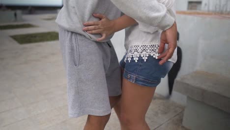 young  hispanic couple dancing and having a good time in slow motion