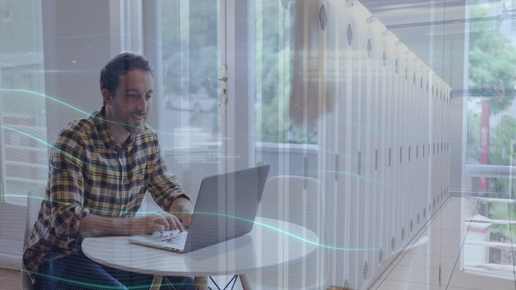 Animation of server room and programming language over caucasian man working over laptop