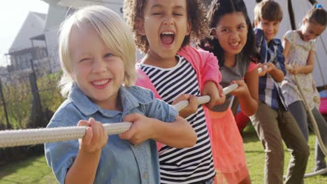 group of happy friend playing tug of war 4k