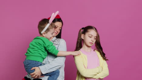 Little-children-having-a-fight-against-pink-background