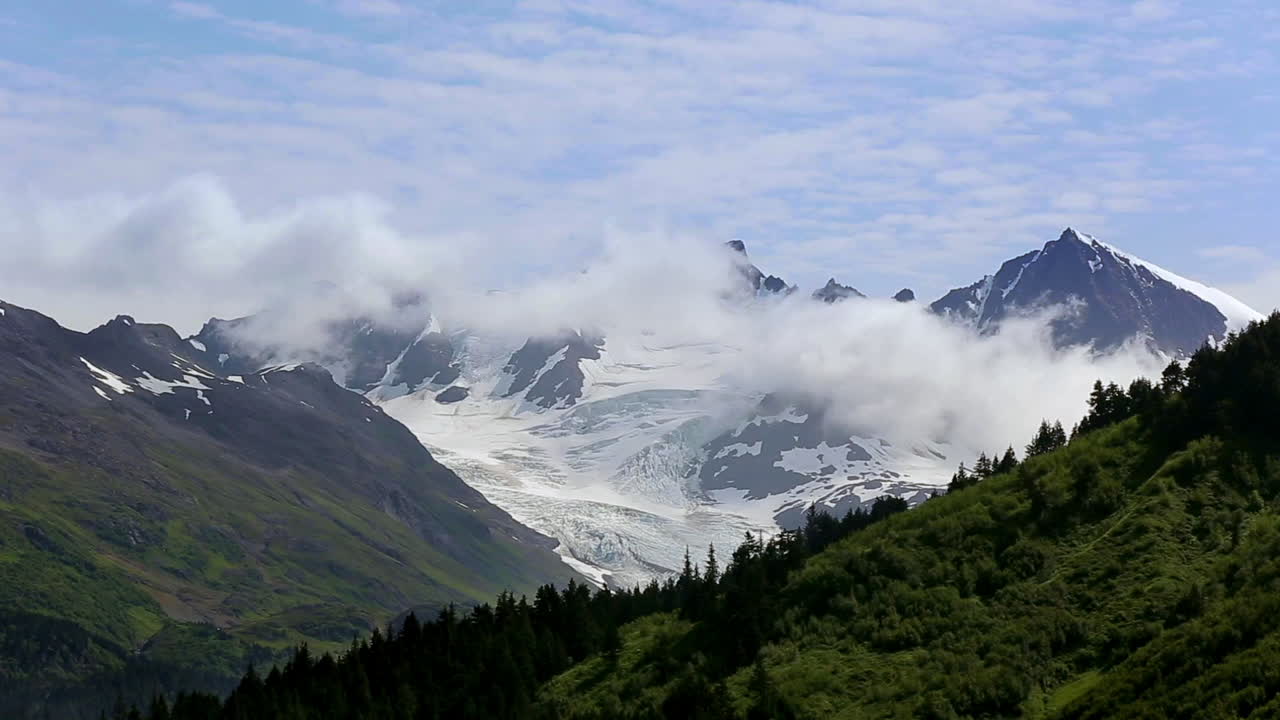 Clouds flying through the rocky mountains.