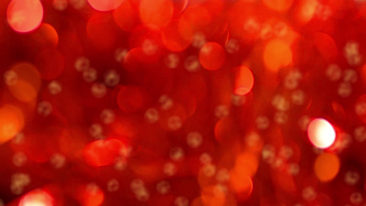 축제 장식: 빛나는 반점과 입자의 추상적인 배경