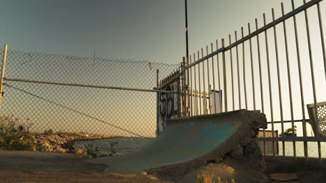 Youngblood-does-tricks-on-concrete-ramp-with-skateboard,-truck-left-view