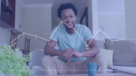 Animation-of-data-processing-over-african-american-man-smiling-and-talking-looking-at-the-camera