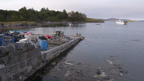 shot of an old stone pier covered in fishing tools and items