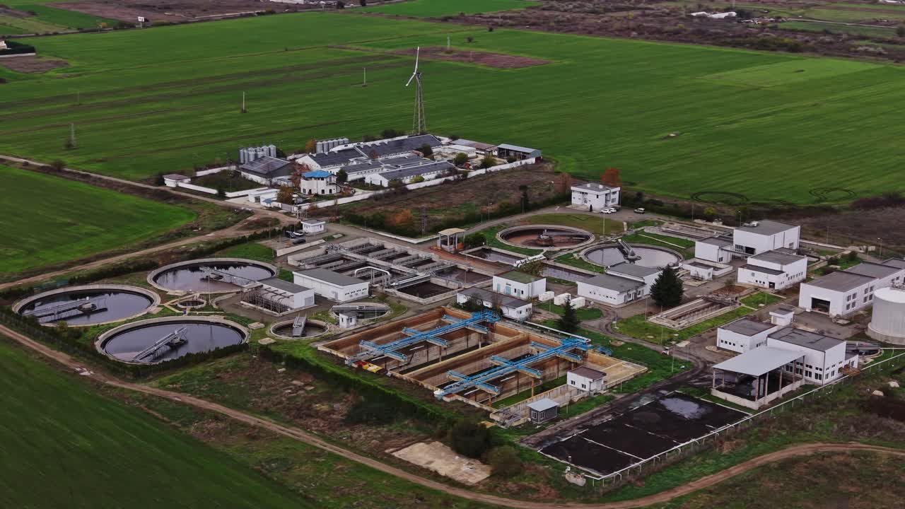 Wastewater treatment facility near green fields in rural area