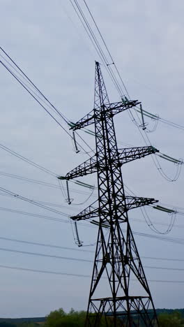 voltage electric transmission tower. high voltage lines and power pylons. vertical video