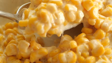 close-up of creamed corn being scooped