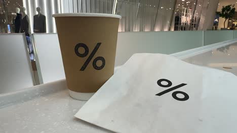 'percentage' sign coffee cup and paper bag - iconsiam shopping centre, bangkok, thailand