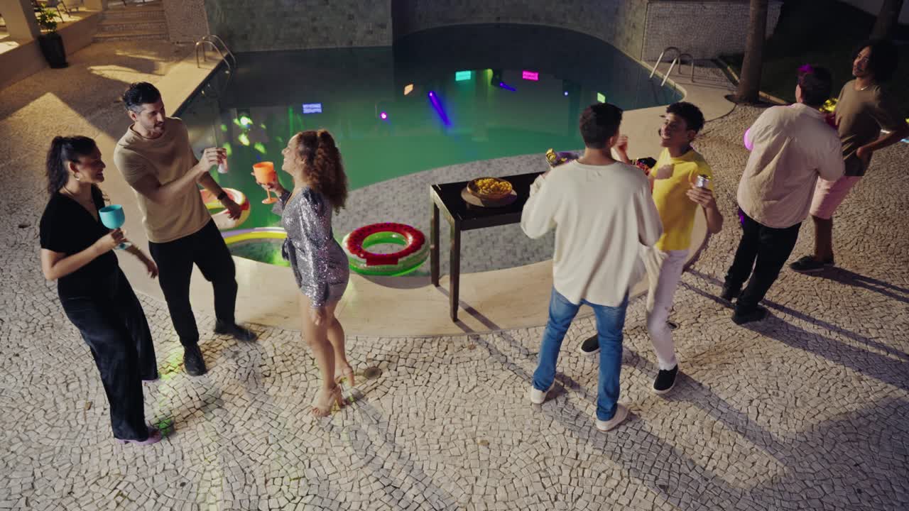Friends Enjoying a Lively Night Pool Party