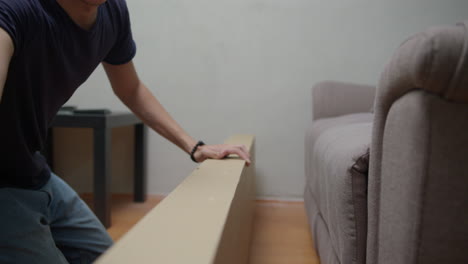 man open a box of forniture to assembly