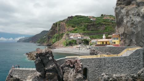 aerial past concrete pathway on rocks revealing secluded beach in madeira