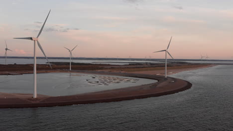 Windturbines-and-aquaculture-during-sunset-on-the-island-Neeltje-Jans,-the-Netherlands