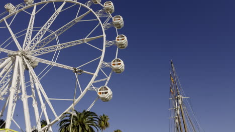 ferris wheel and sailboat on a sunny day