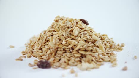 crunchy granola scattered on white background 4k