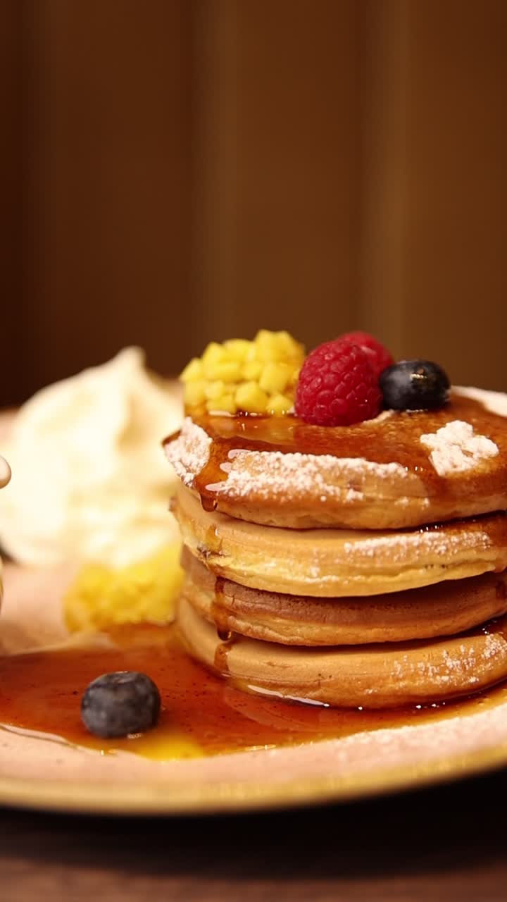 Stack of pancakes with syrup and berries