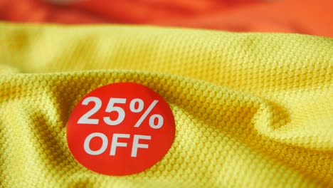 25% off sale sign on yellow fabric