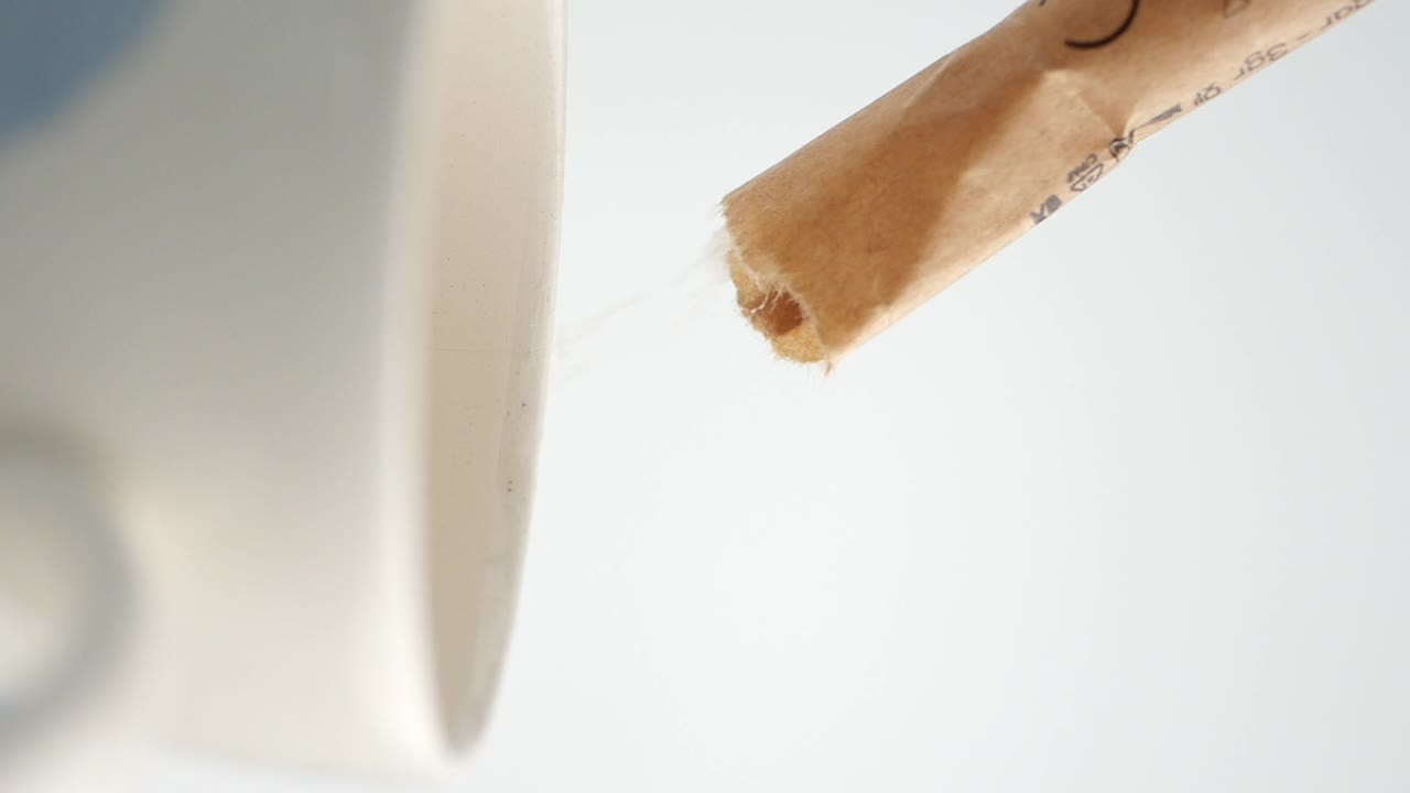 Adding sugar to a cup