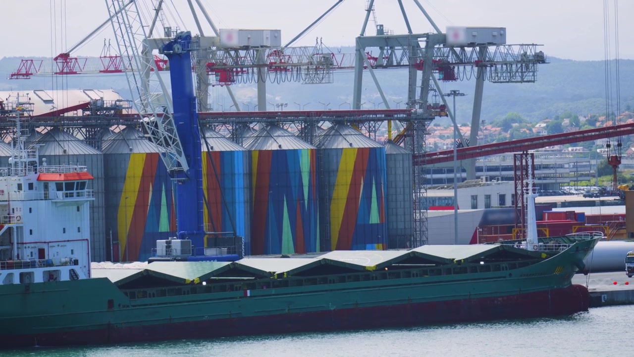 Cargo Transport Vessel Ready to be Loaded with Goods from nearby Industrial Cranes in Spain.