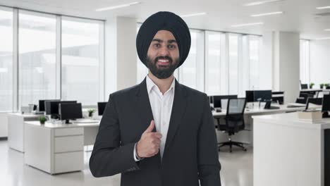 happy sikh indian businessman showing thumbs up