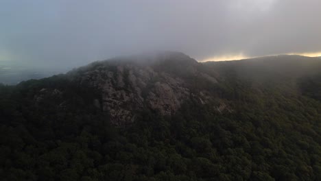 An-aerial-view-over-Storm-King-Mountain,-located-on-the-west-bank-of-the-Hudson-River-in-NY-on-a-cloudy-morning