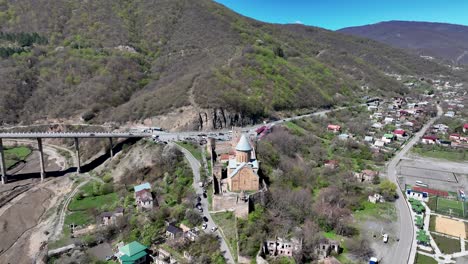 Aerial-View-Of-Ananuri-Church-And-Castle-Complex-On-The-Aragvi-River-In-Georgia---drone-shot