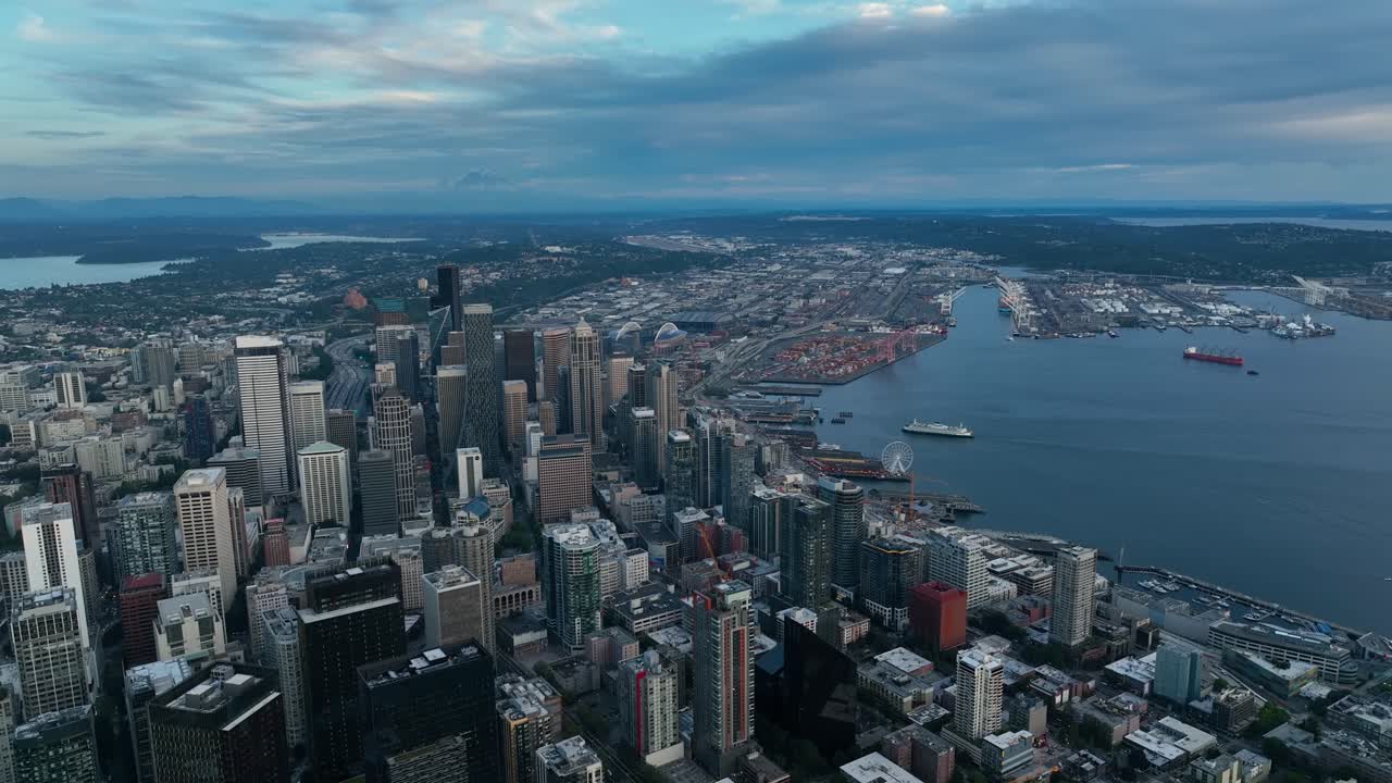 Wide aerial view of Seattle's gloomy downtown skyscrapers with a storm on the horizon