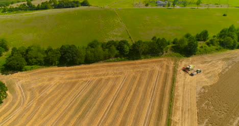 Combine-Harvester-And-Tractor-Working-In-Agricultural-Field-