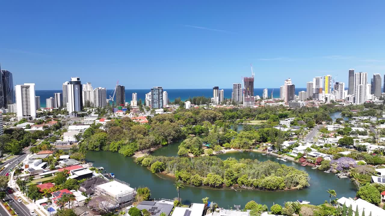 Gold Coast city with tall buildings and canal during beautiful day. Drone panoramic. Australian cityscape.