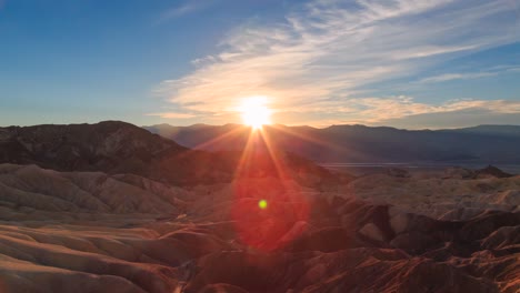 amazing desert golden sunset time lapse with lens flare and unique geological landscape from zabriskie point, death valley national park, california, united states