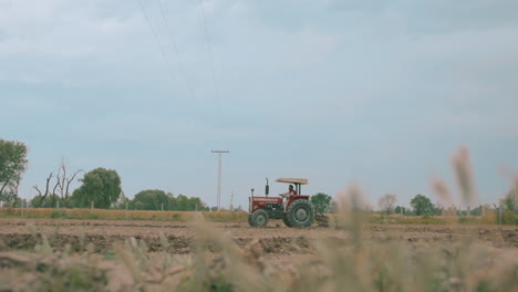 this captivating beauty of a tractor diligently working in a sprawling farm