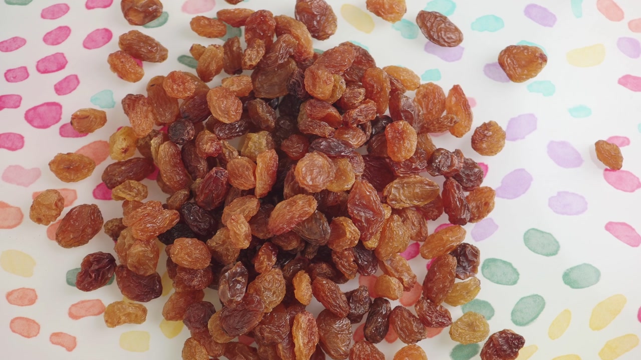 Pile of Raisins on a Colorful Polka Dot Background