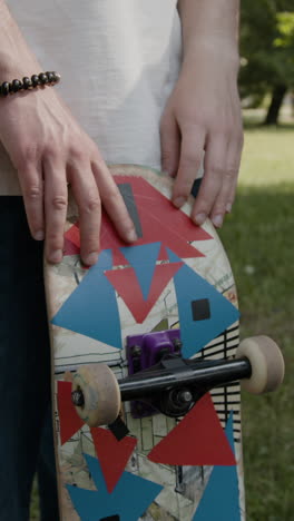 close-up of a person holding a skateboard