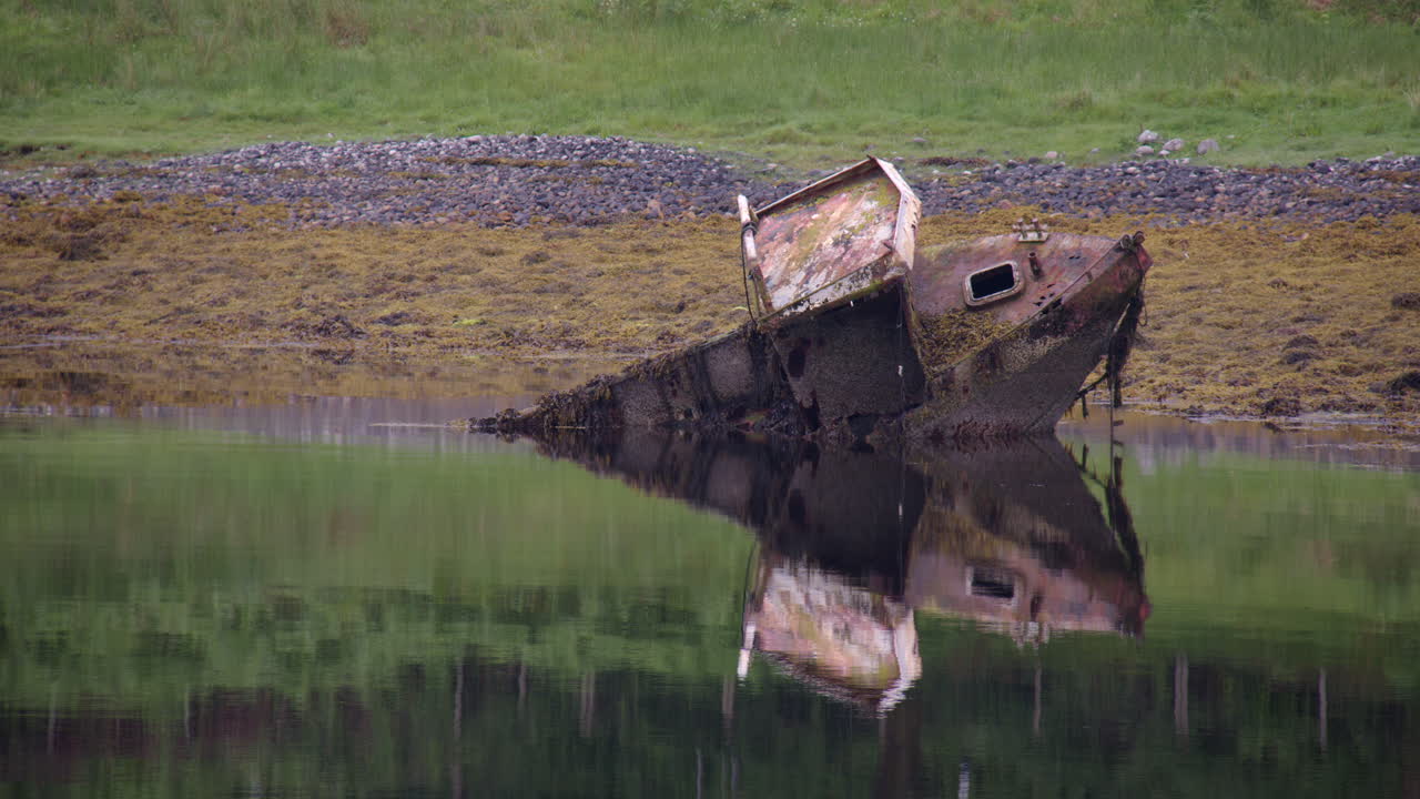 A wrecked fishing boat on the shores of Loch Etive showing the right starboard side at Eilean Traighe