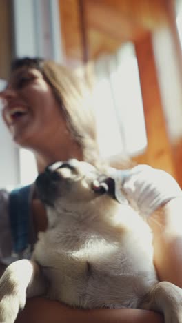 woman laughing with her pug