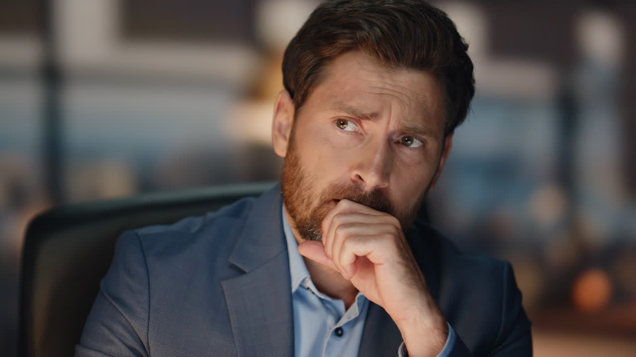 preocupado jefe pensando cara en el gabinete de la noche primer plano. molesto hombre reflexionando tarea