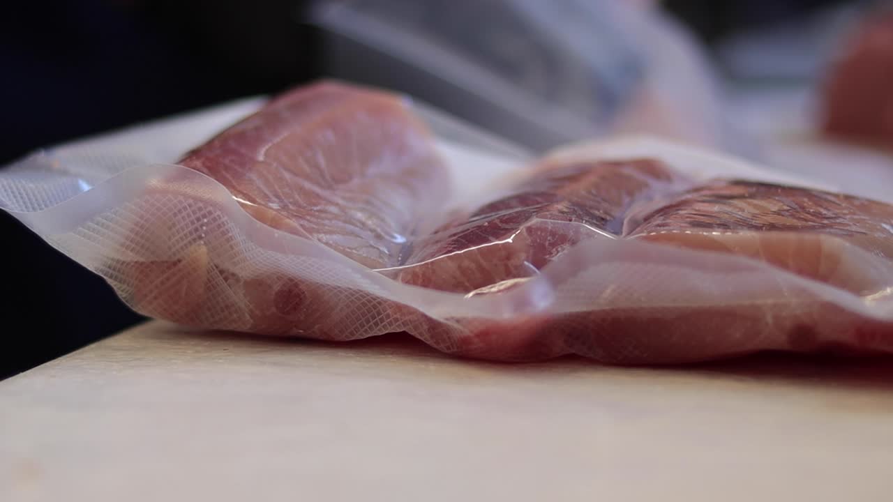 Packing freshly caught fish with careful wrapping on Cedros Island, ensuring quality and freshness using vacuum sealing techniques