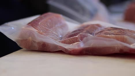 packing freshly caught fish with careful wrapping on cedros island, ensuring quality and freshness using vacuum sealing techniques