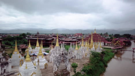 aerial shot drifting above pagodas at inle lake, myanmar (burma) - dolly out