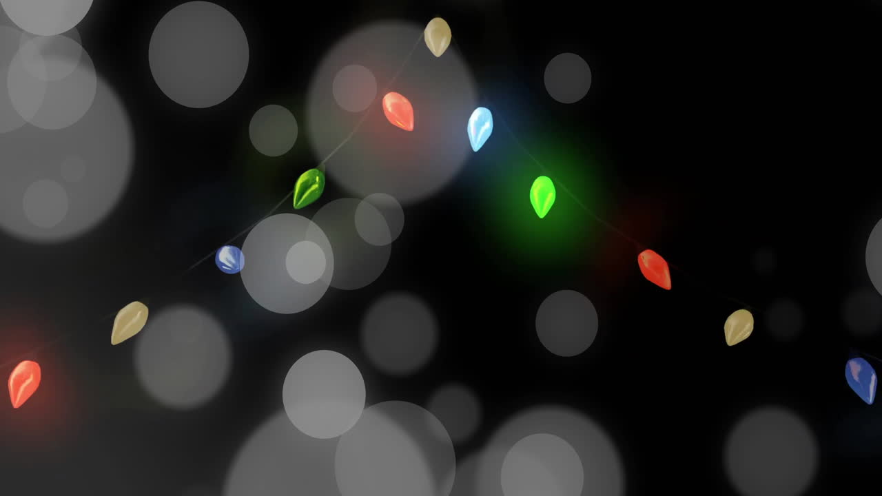 Animation of light spots over fairy lights on black background
