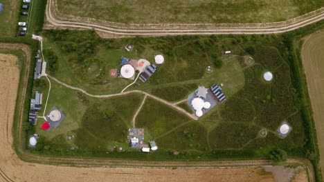 drone shot of luxury campsite with yurts and teepees in countryside