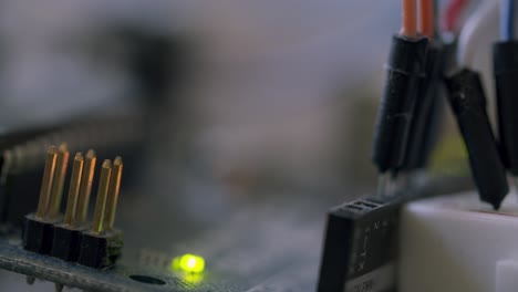 macro shot of transistors, cable and a led light on a circuit board