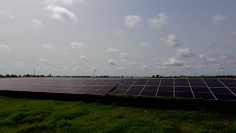 Wide-panoramic-view-time-lapse-of-photovoltaic-renewable-solar-energy-panel-arrays-at-NAWEC-TBEA-photovoltaic-farm-power-plant-under-construction---Jambur-Gambia,-Africa