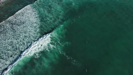 surfers enjoying waves in coast of zumaia spain, drone view