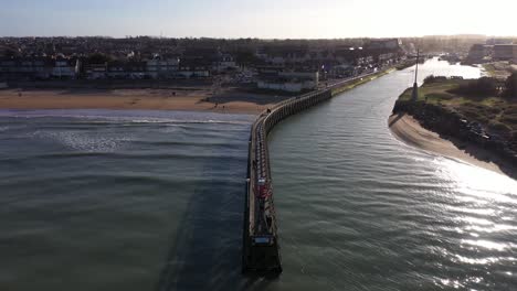 aerial-shot-of-a-pier-in-courseulles-sur-mer-with-a-view-on-the-city