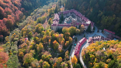 aerial view of the rila monastery surrounded by colorful autumn foliage in the rila mountains, bulgaria