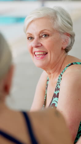 two women laughing and having fun by the pool